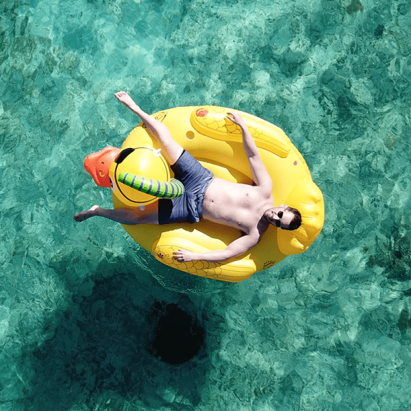 top down view of someone laying on the float in open water